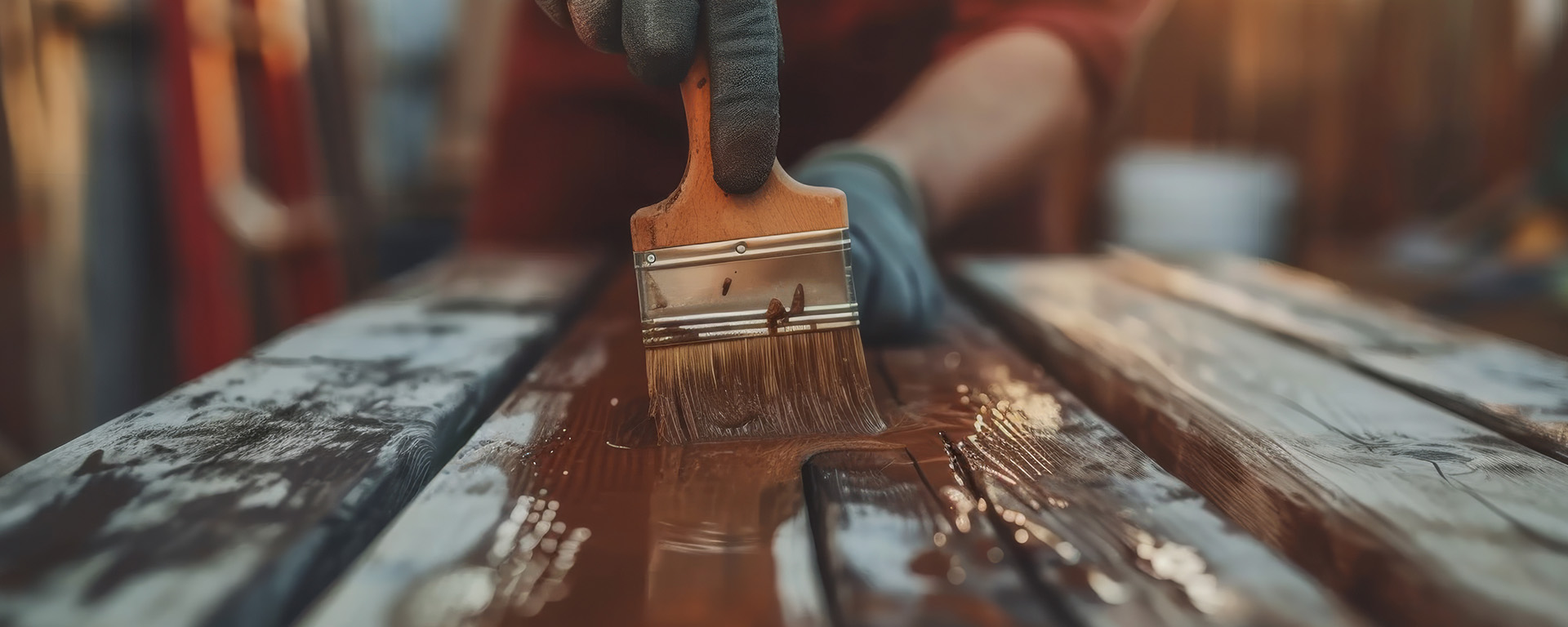 Photo of a professional painter staining a door.